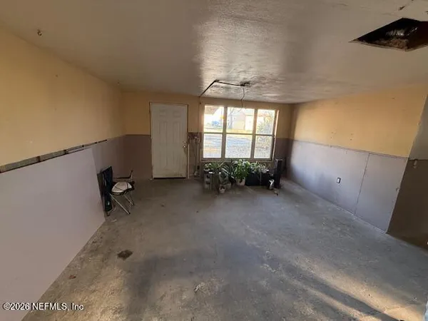 a view of wooden floor and windows in a room