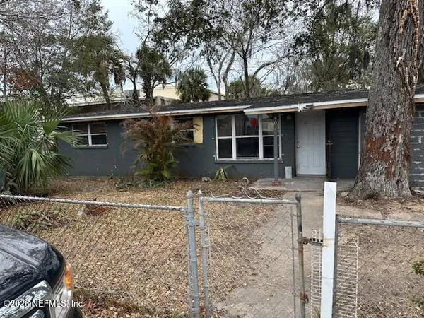 a backyard of a house with table and chairs