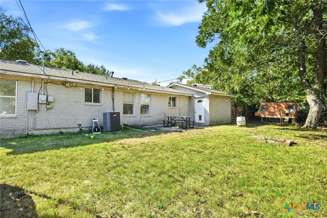 904 Kirk Street Taylor, TX 76574 - Photo 22 of 25 Back of Home/Yard with door to the bonus room.