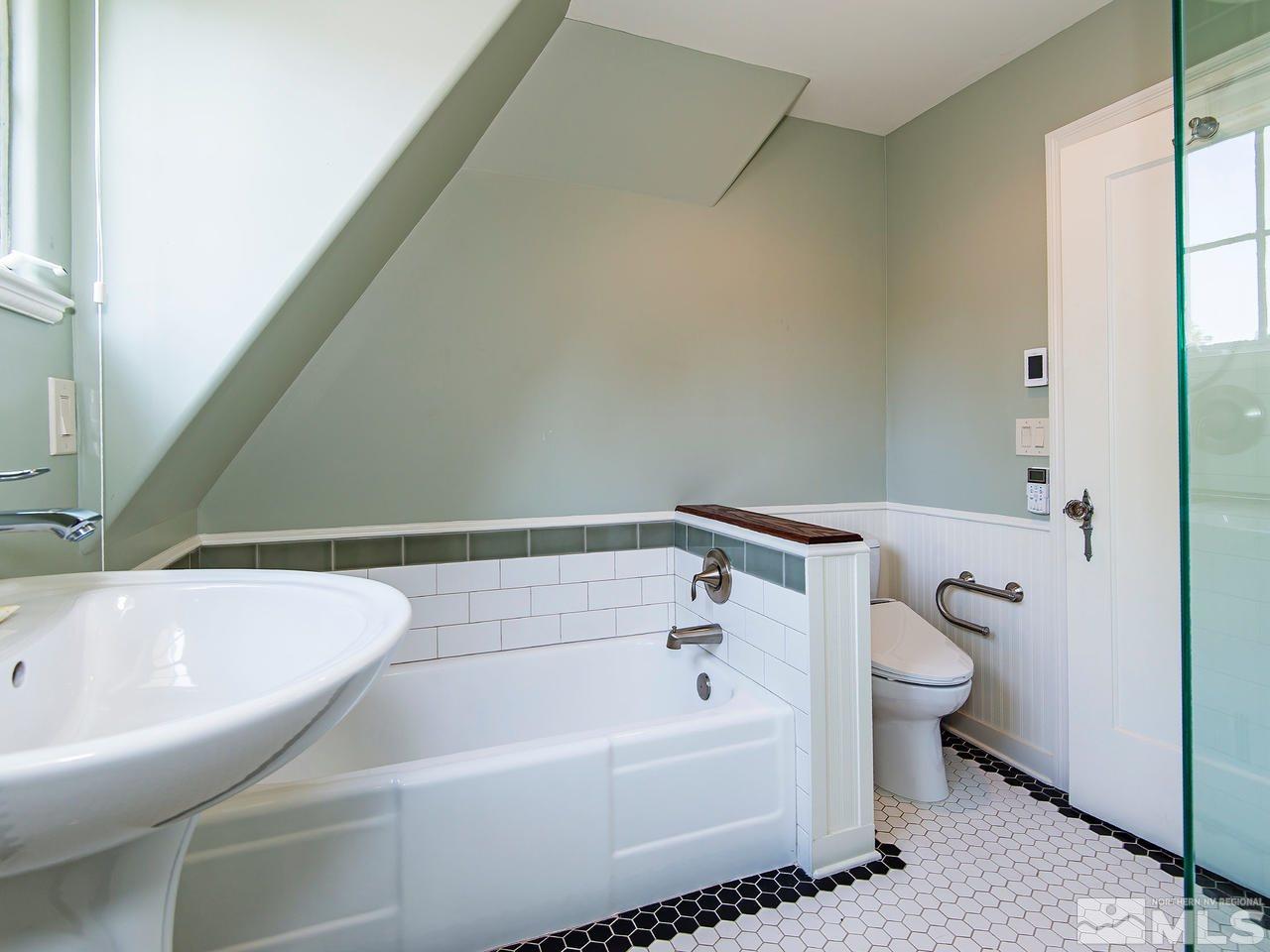 602 John Fremont Drive, Unit RENO NV Reno, NV 89509 - Photo 16 of 24 a bathroom with a bathtub and a toilet