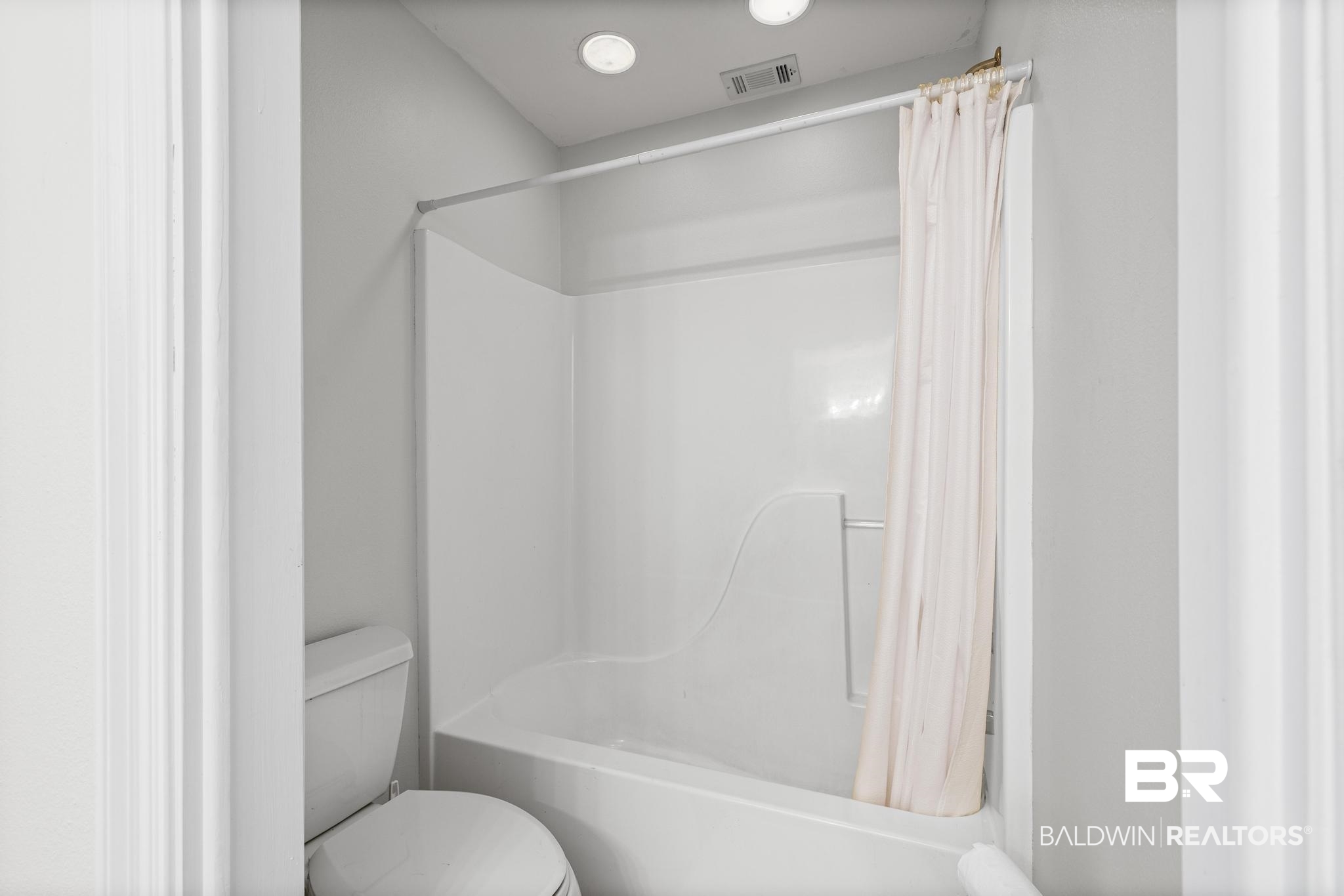32875 Faircloth Road Lillian, AL 36549 - Photo 47 of 85 Full bathroom with toilet and shower / tub combo with curtain