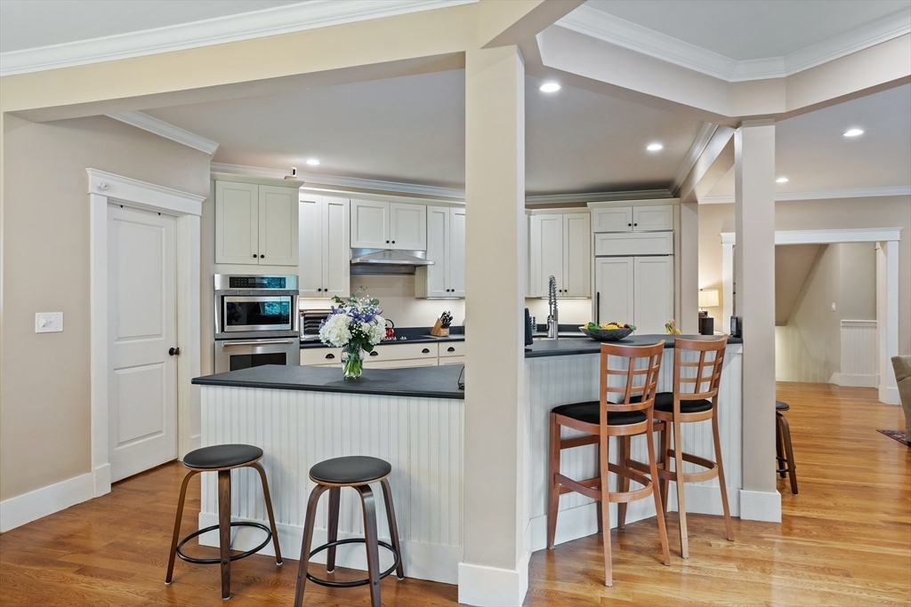 5 Walnut Street Lexington, MA 02421 - Photo 5 of 34 a kitchen with stainless steel appliances kitchen island granite countertop a dining table chairs and view living room