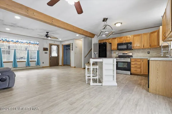 a kitchen with stainless steel appliances granite countertop a refrigerator and microwave
