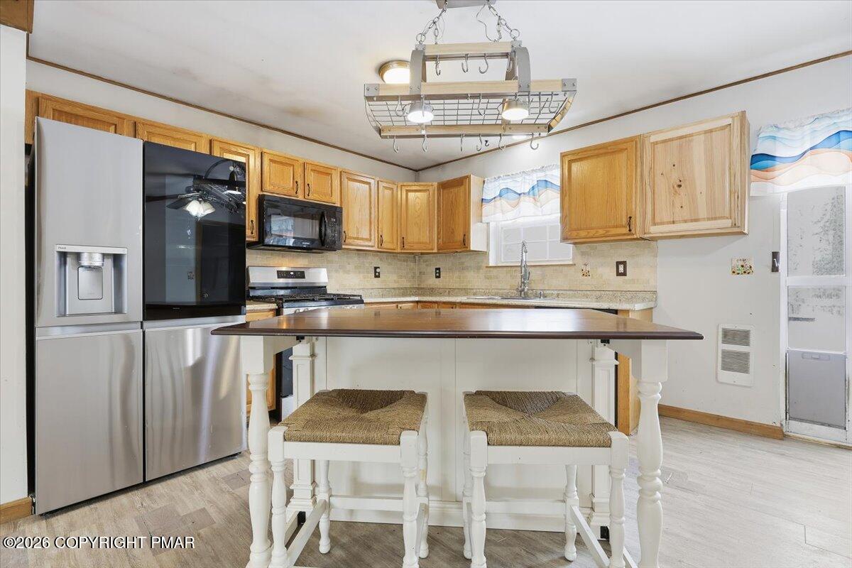 199 Magic Mountain Road Henryville, PA 18332 - Photo 15 of 74 a kitchen with stainless steel appliances granite countertop a refrigerator and microwave