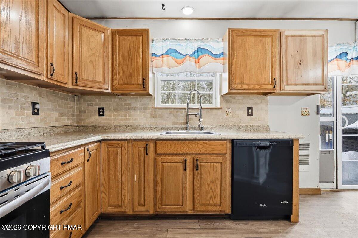 199 Magic Mountain Road Henryville, PA 18332 - Photo 18 of 74 a kitchen with stainless steel appliances granite countertop a sink and a window