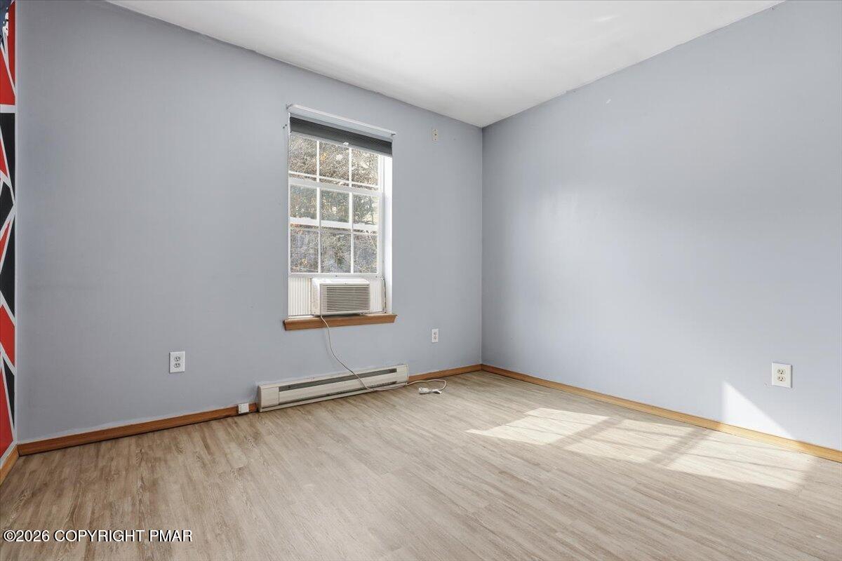 199 Magic Mountain Road Henryville, PA 18332 - Photo 29 of 74 an empty room with wooden floor and windows