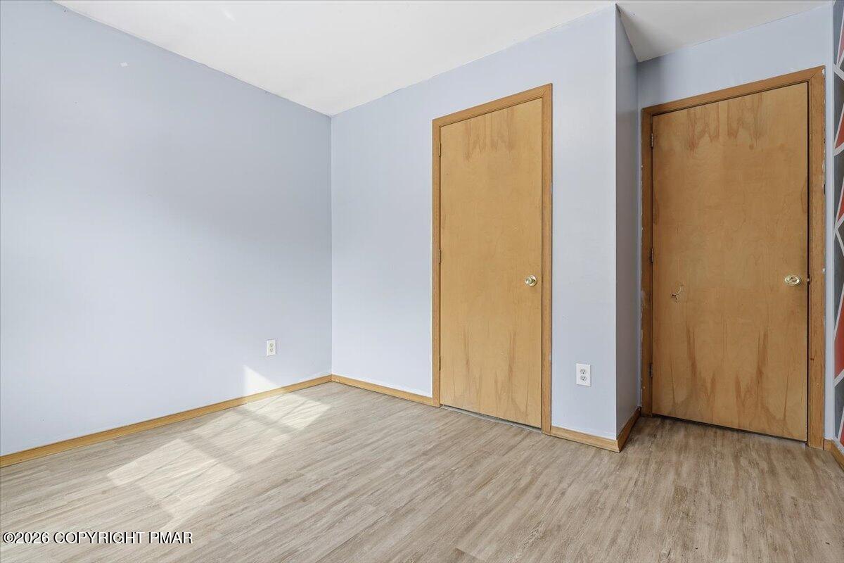 199 Magic Mountain Road Henryville, PA 18332 - Photo 30 of 74 an empty room with wooden floor and a window