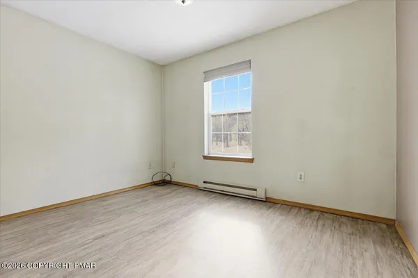 a living room with furniture and a ceiling fan