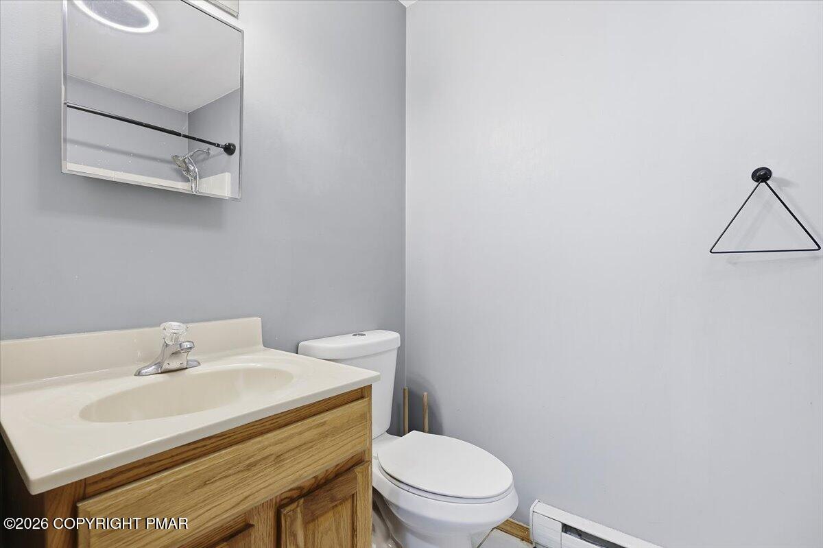 199 Magic Mountain Road Henryville, PA 18332 - Photo 34 of 74 a bathroom with a sink a toilet and vanity