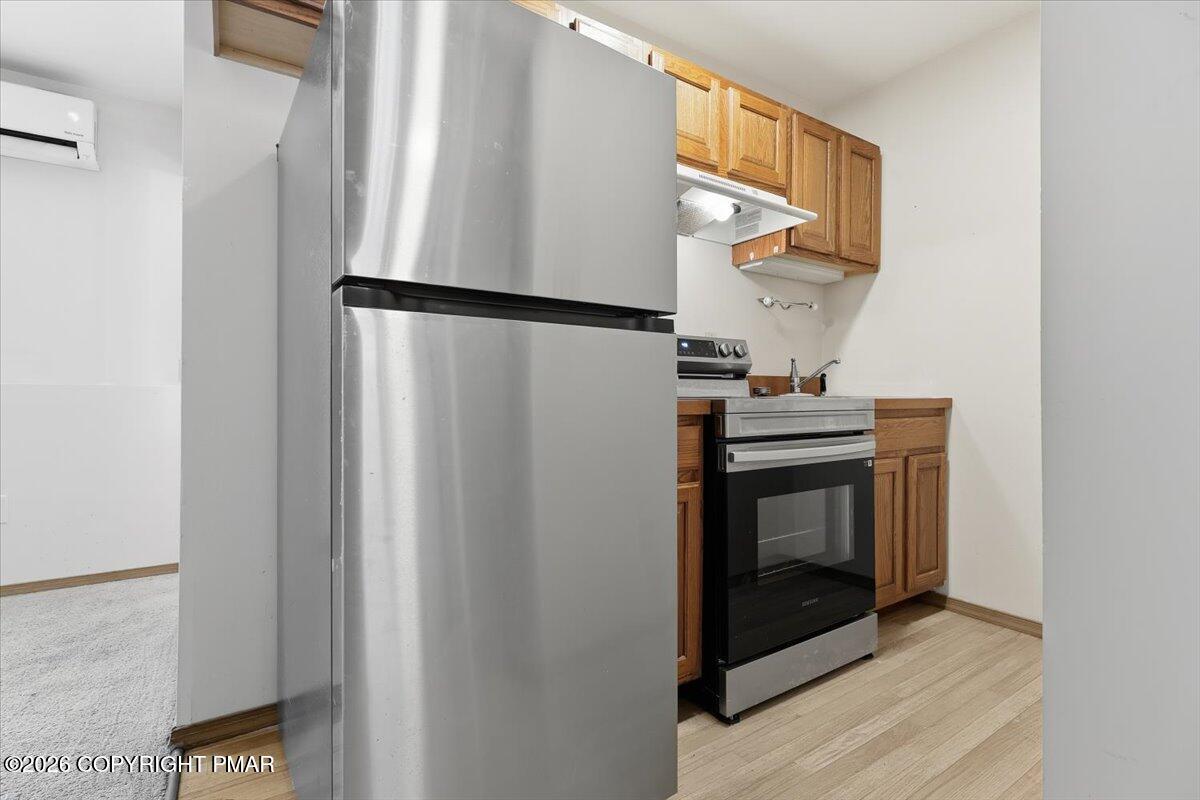 199 Magic Mountain Road Henryville, PA 18332 - Photo 38 of 74 a kitchen with stainless steel appliances granite countertop a refrigerator and a stove