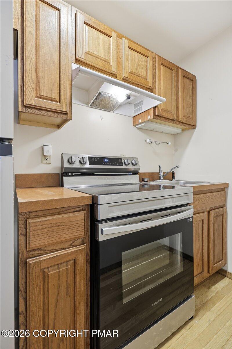 199 Magic Mountain Road Henryville, PA 18332 - Photo 41 of 74 a kitchen with stainless steel appliances granite countertop a stove and a sink