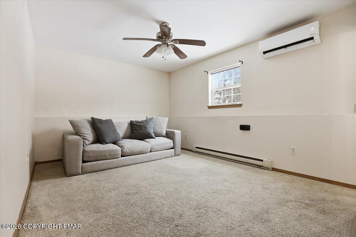 199 Magic Mountain Road Henryville, PA 18332 - Photo 42 of 74 a living room with furniture and a ceiling fan