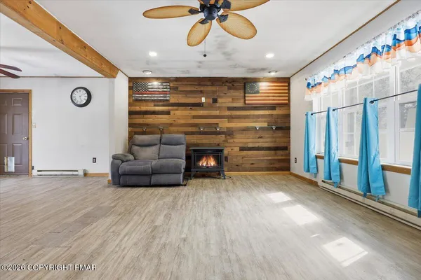 a view of an empty room with a ceiling fan
