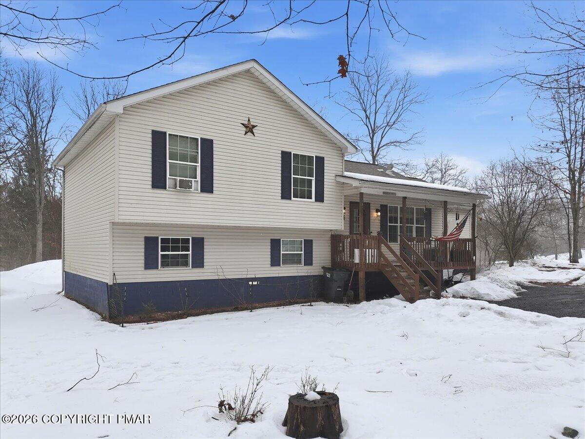 199 Magic Mountain Road Henryville, PA 18332 - Photo 67 of 74 a front view of a house with a yard covered in snow