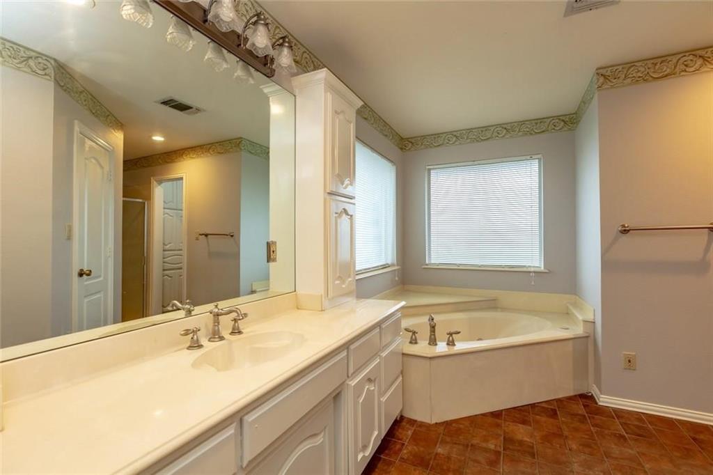 123 Double Tree Lane Lipan, TX 76462 - Photo 22 of 25 Shower and corner tub - plus an exterior door leading to the back yard.