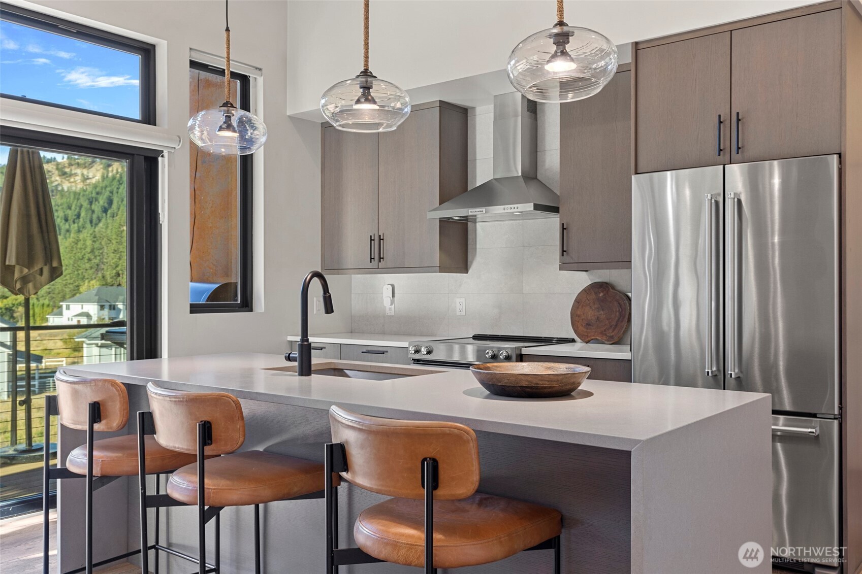 10695 Eagle Creek Road Leavenworth, WA 98826 - Photo 16 of 39 a kitchen with stainless steel appliances a table chairs and a refrigerator