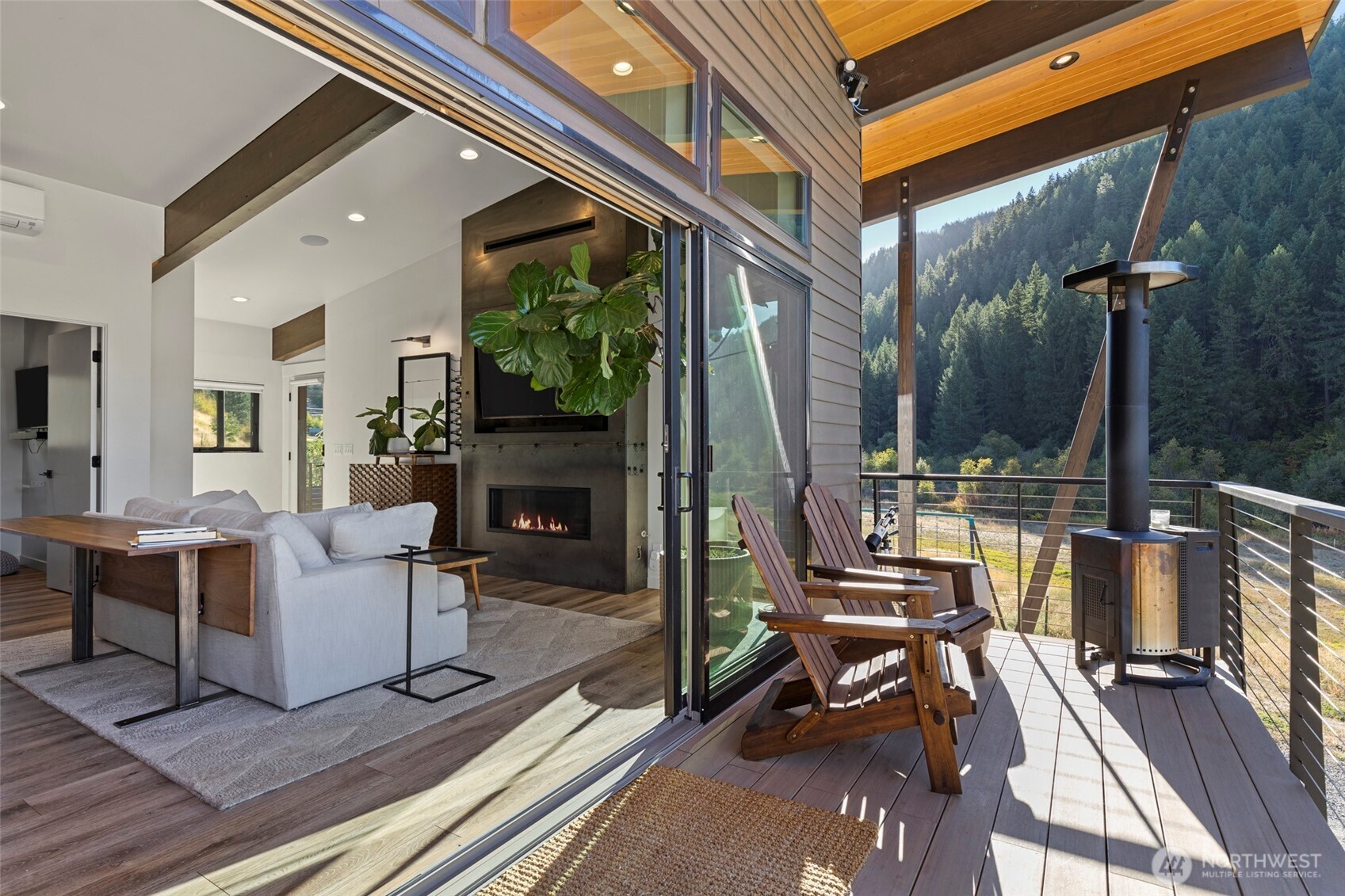 10695 Eagle Creek Road Leavenworth, WA 98826 - Photo 20 of 39 a living room with furniture a fireplace and a flat screen tv