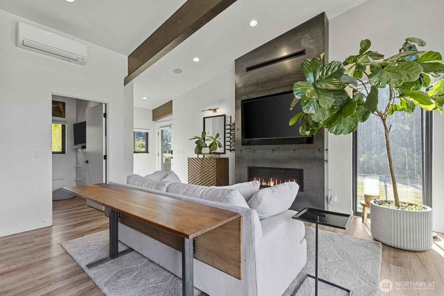 10695 Eagle Creek Road Leavenworth, WA 98826 - Photo 7 of 39 a living room with furniture a fireplace and a potted plant