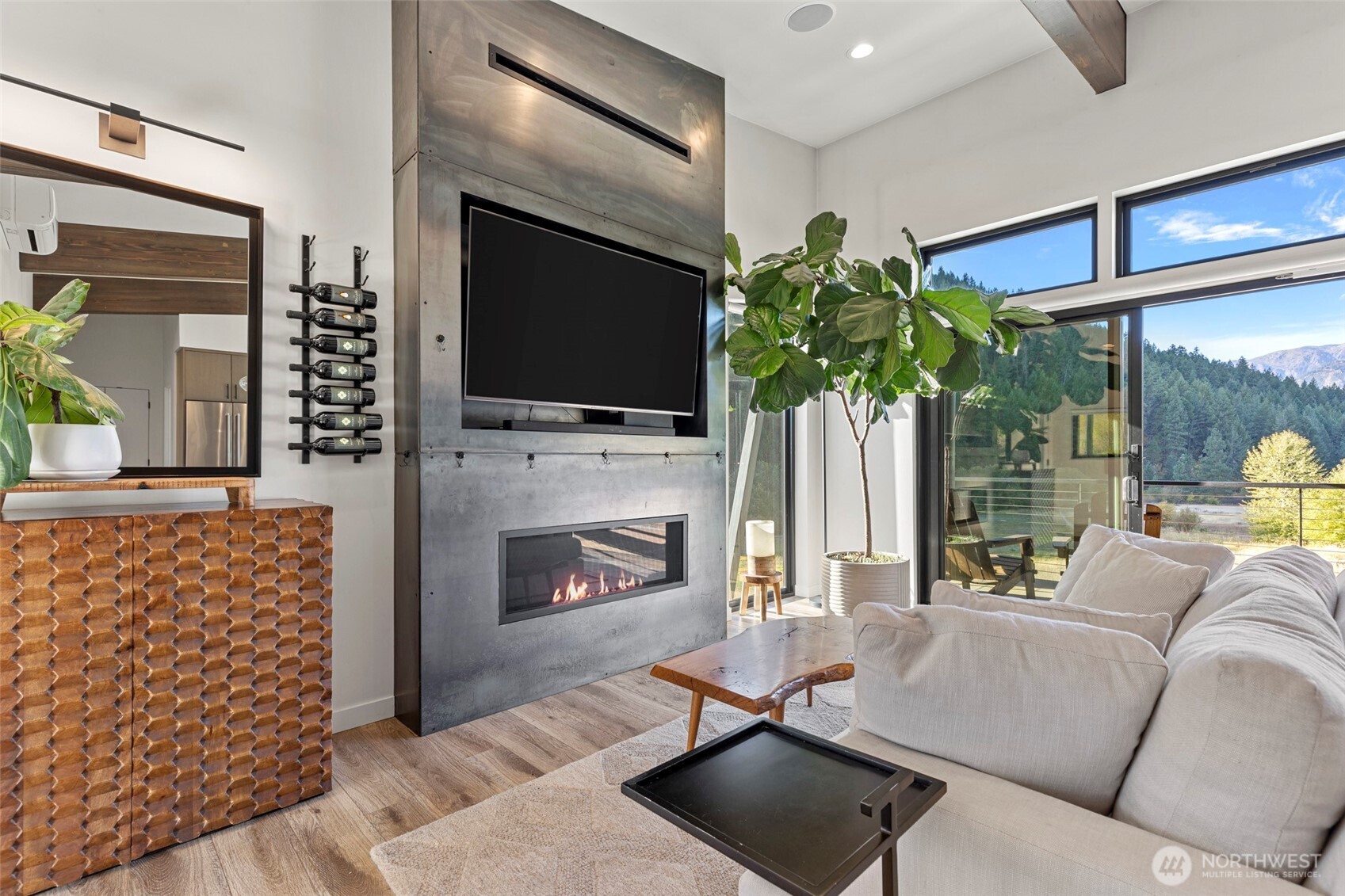 10695 Eagle Creek Road Leavenworth, WA 98826 - Photo 9 of 39 a living room with furniture a flat screen tv and a fireplace