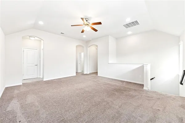 a view of a livingroom with a ceiling fan and window
