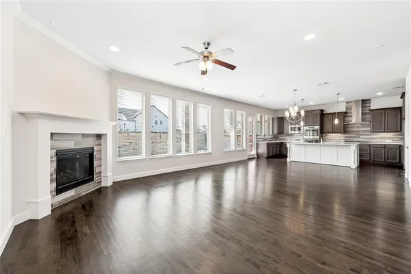 a view of a kitchen with a stove wooden cabinets and a fireplace