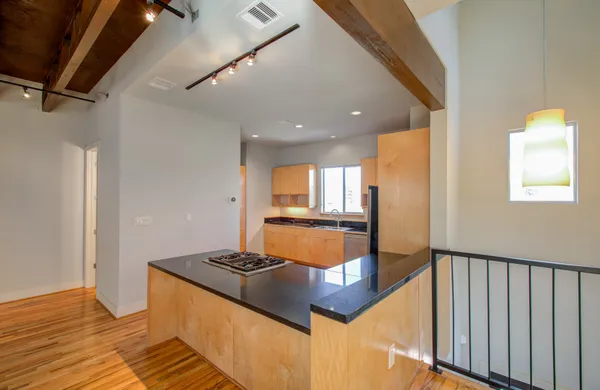 a kitchen with stainless steel appliances granite countertop a sink and a refrigerator