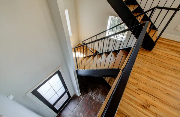 a view of stairs and wooden floor