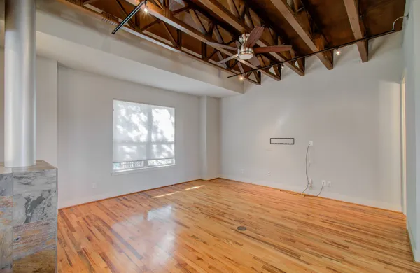 a view of a room with wooden floor