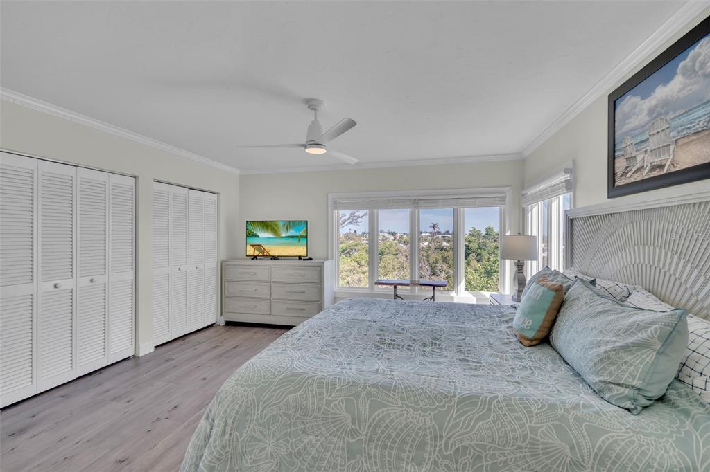 848 Evergreen Way Longboat Key, FL 34228 - Photo 17 of 66 a bedroom with furniture and a large window