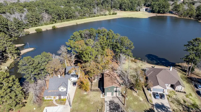 an aerial view of a house a yard and lake view