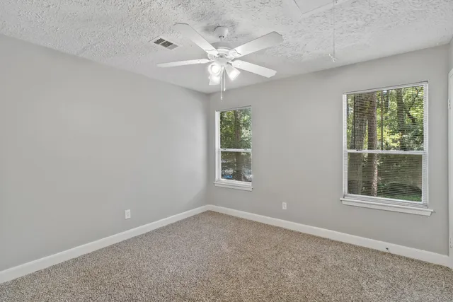 a view of an empty room with a fan