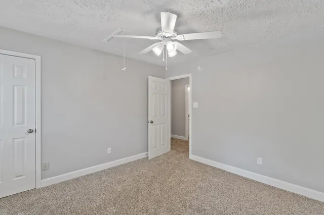 a bathroom with a granite countertop sink a toilet and a mirror