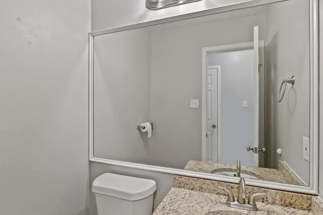 an empty room with windows and ceiling fan