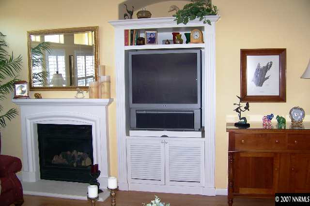 1635 Arboleda Drive Reno, NV 89521 - Photo 4 of 9 a living room with a fireplace and a flat screen tv