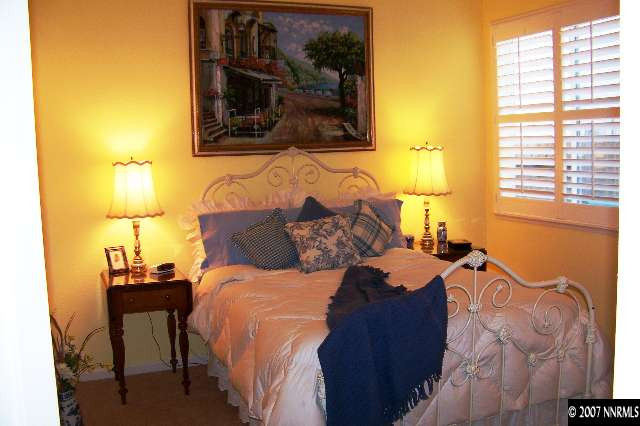 1635 Arboleda Drive Reno, NV 89521 - Photo 8 of 9 a bed sitting in a bedroom next to a window