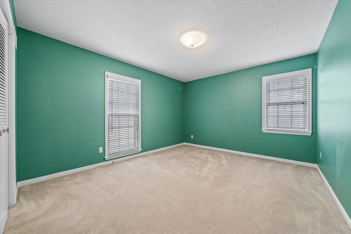 2587 McVay Road Memphis, TN 38119 - Photo 21 of 35 Bedroom featuring light carpet and a textured ceiling