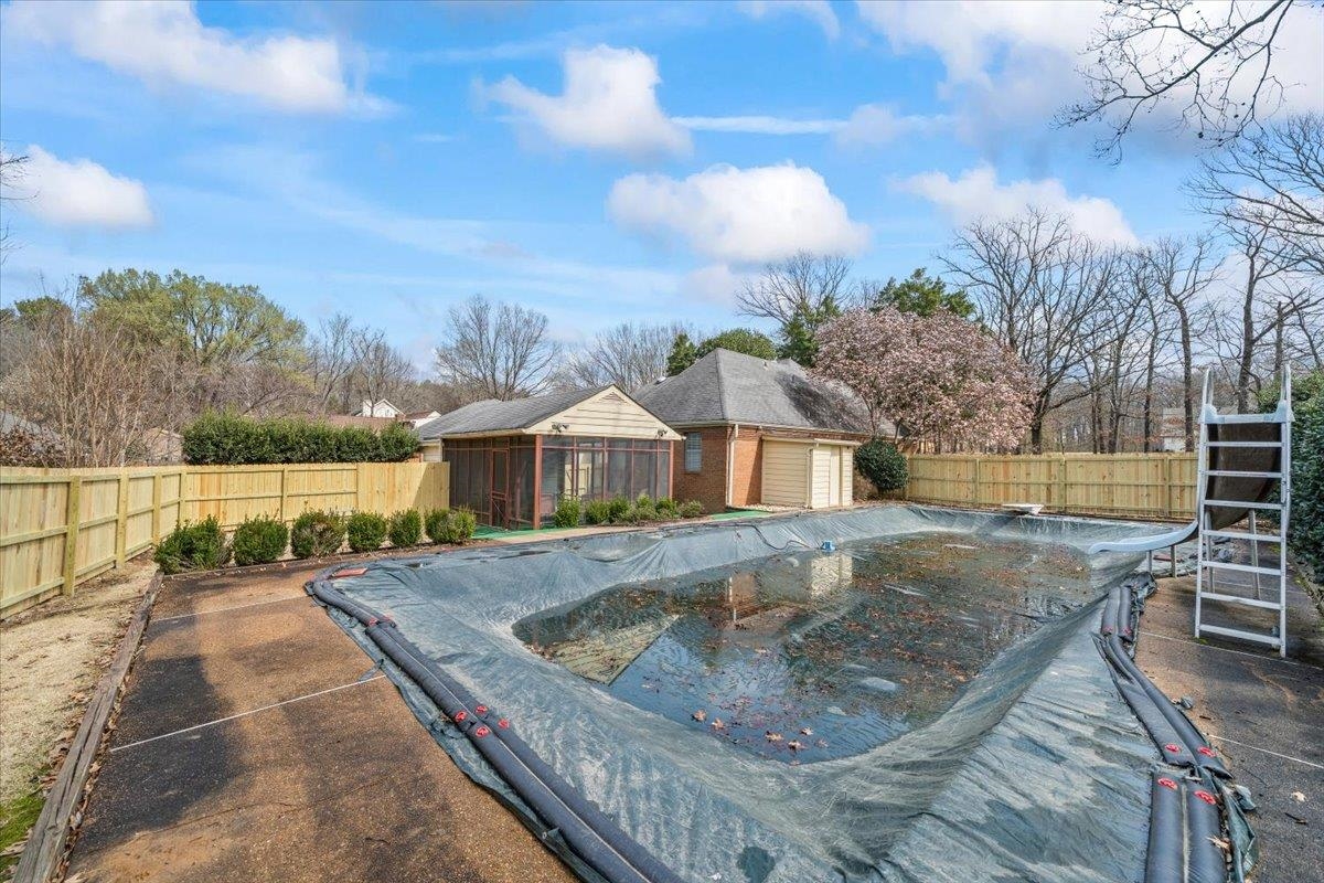 2587 McVay Road Memphis, TN 38119 - Photo 30 of 35 View of pool with a fenced backyard and a water slide