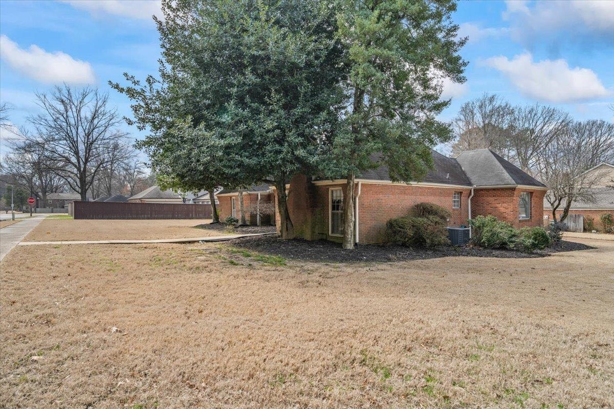 2587 McVay Road Memphis, TN 38119 - Photo 3 of 35 View of property exterior featuring brick siding and a cooling unit