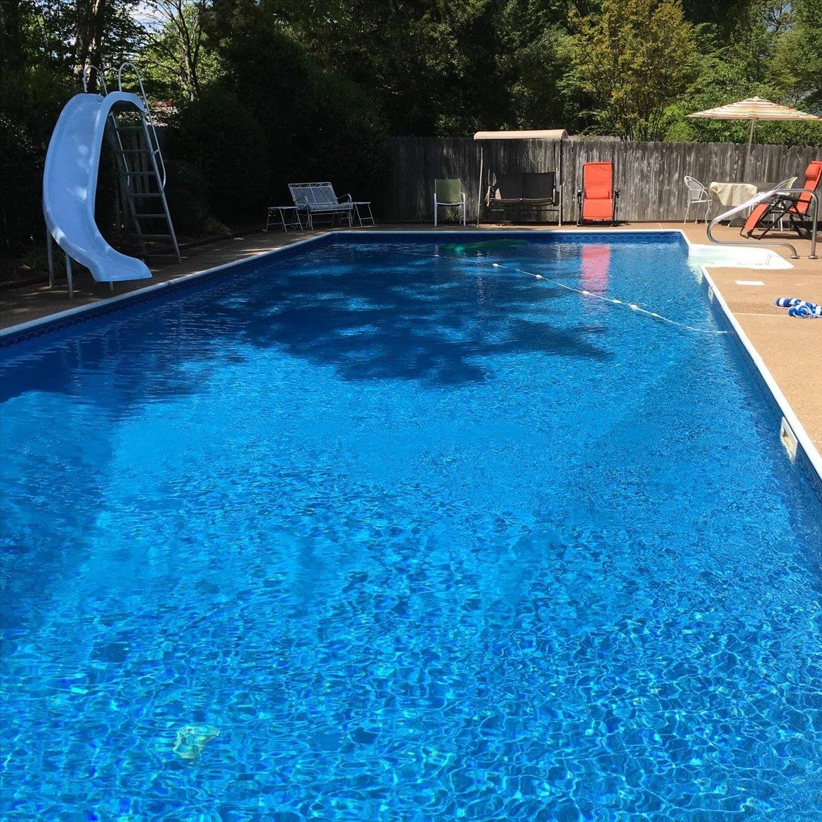 2587 McVay Road Memphis, TN 38119 - Photo 31 of 35 photo taken in the summer. View of swimming pool with a water slide, a fenced backyard, and patio surround