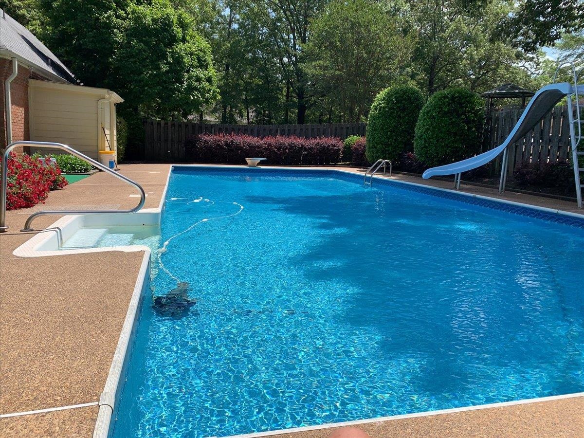 2587 McVay Road Memphis, TN 38119 - Photo 34 of 35 Photo taken in the summer. View of swimming pool with a fenced backyard and a water slide