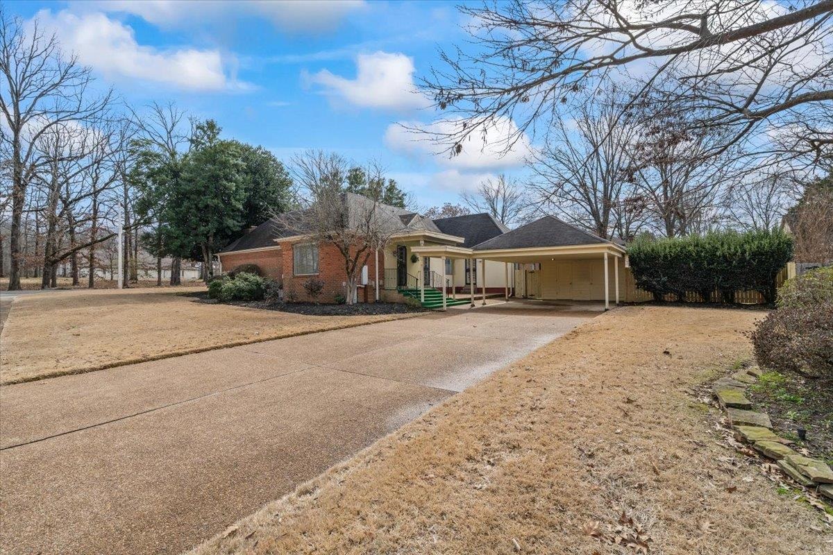 2587 McVay Road Memphis, TN 38119 - Photo 4 of 35 View of front of home with driveway, an attached carport, covered porch, and brick siding