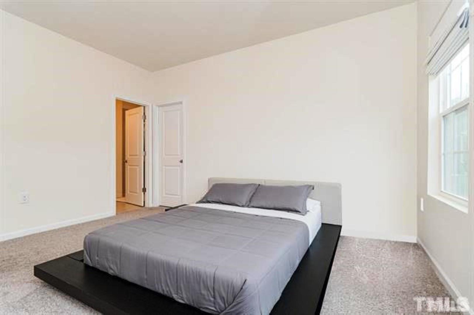 1118 Epiphany Road Morrisville, NC 27560 - Photo 11 of 20 a bedroom with a bed and window