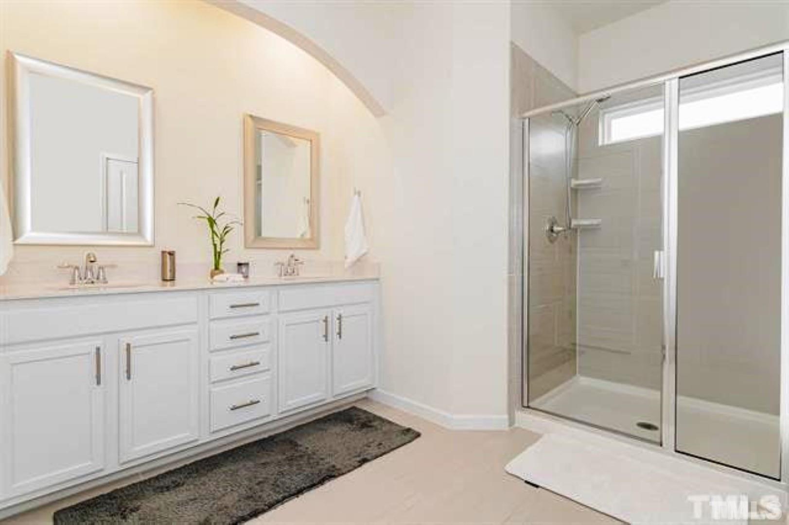 1118 Epiphany Road Morrisville, NC 27560 - Photo 12 of 20 a bathroom with a shower sink and mirror