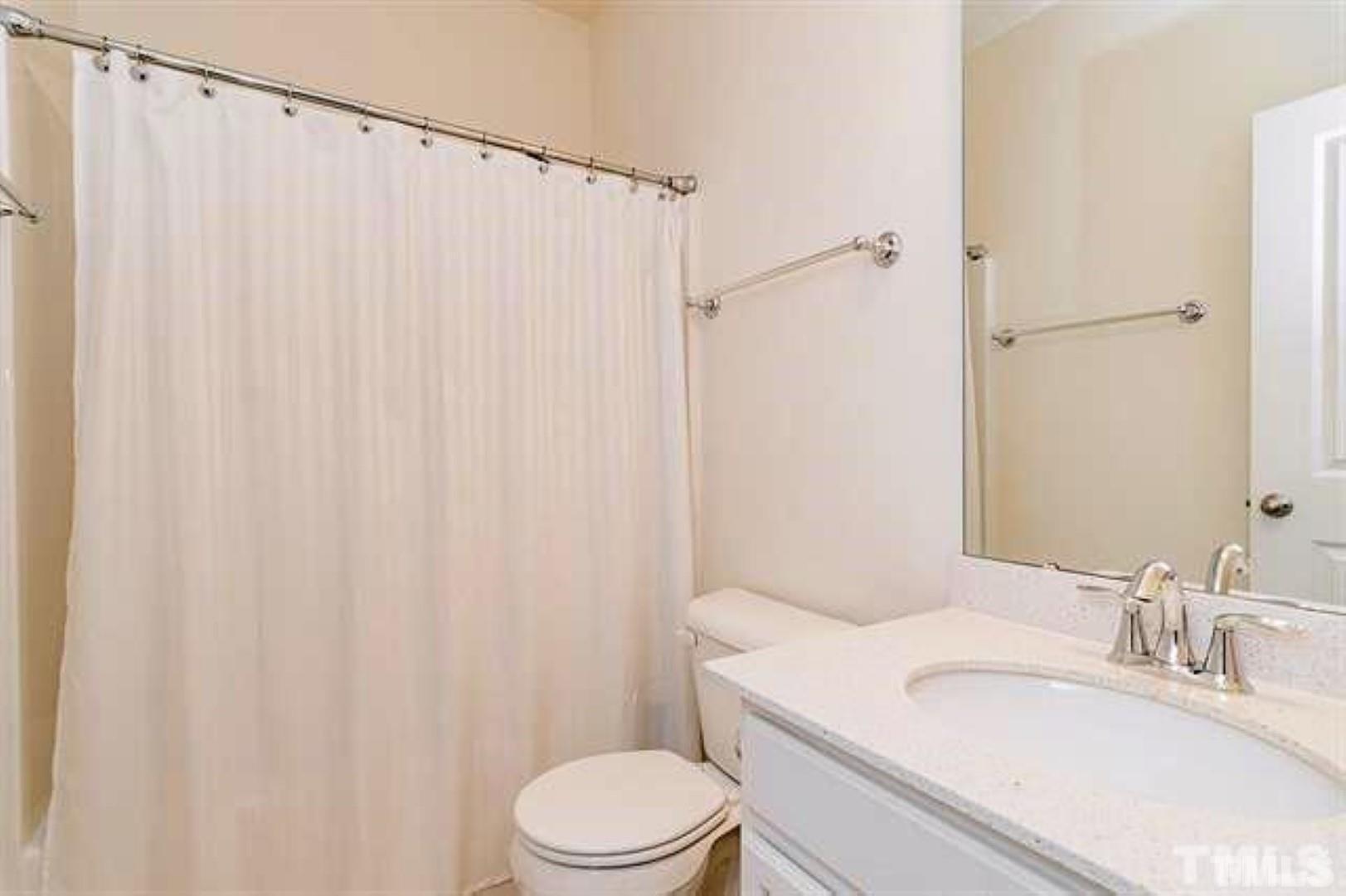 1118 Epiphany Road Morrisville, NC 27560 - Photo 18 of 20 a bathroom with a sink a toilet and shower