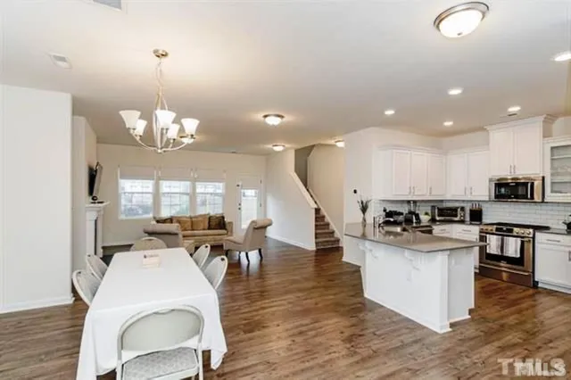 a large kitchen with a table and chairs