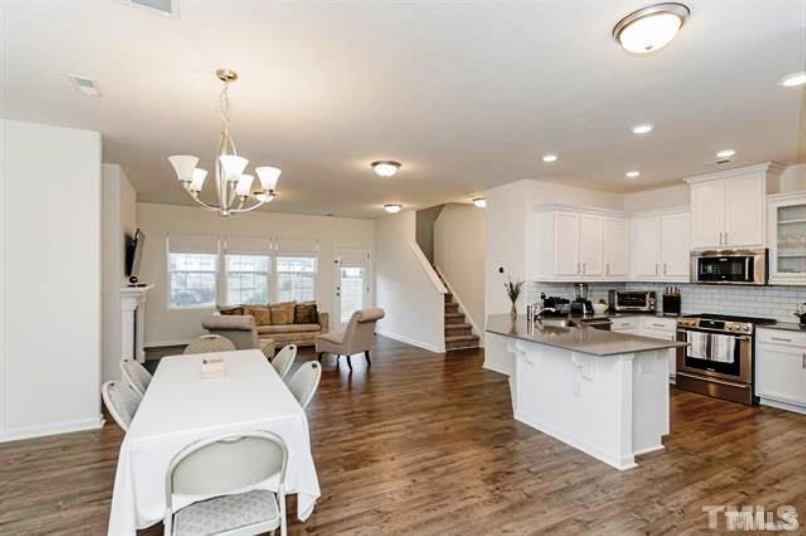 1118 Epiphany Road Morrisville, NC 27560 - Photo 3 of 20 a large kitchen with a table and chairs