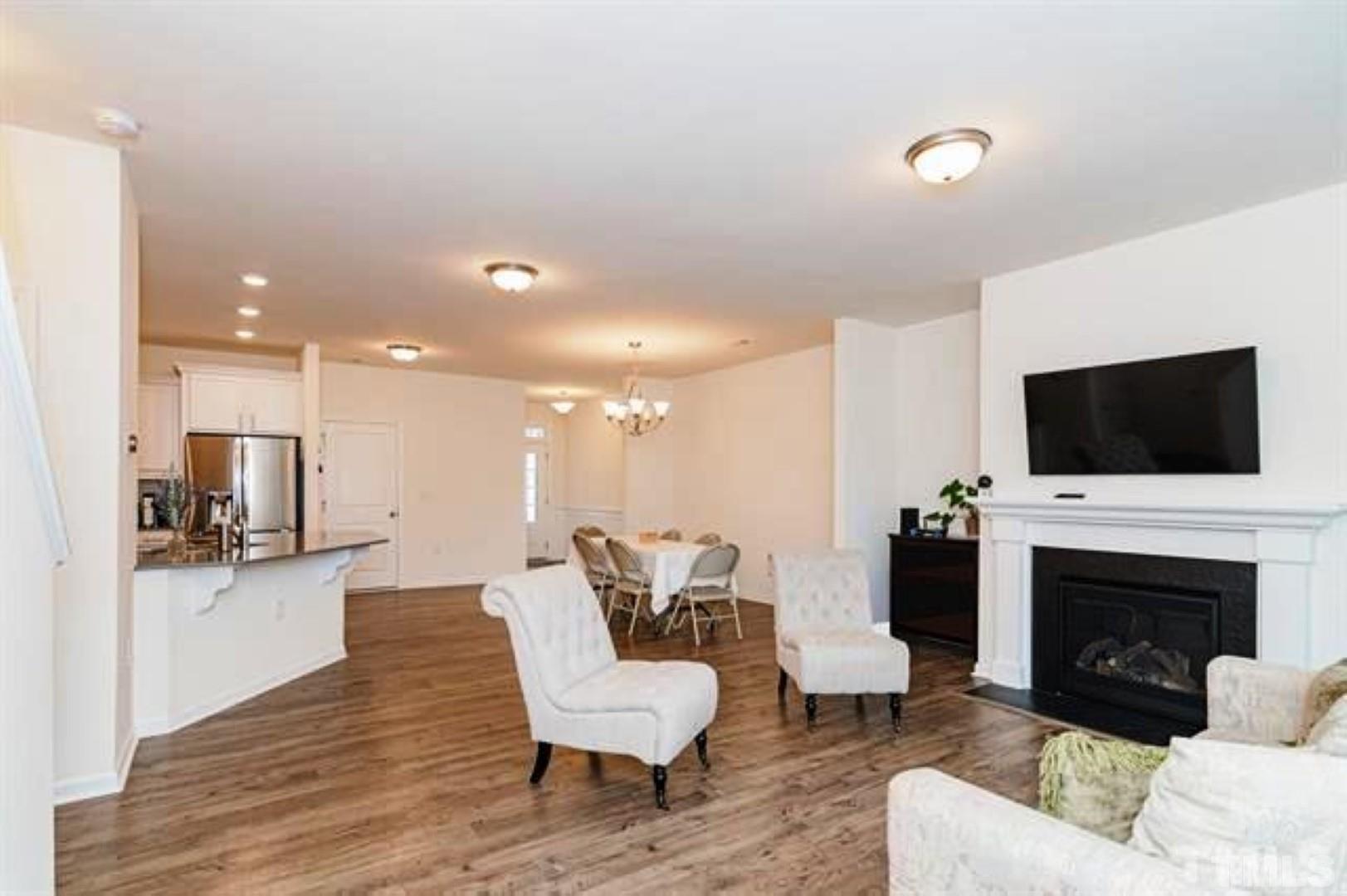 1118 Epiphany Road Morrisville, NC 27560 - Photo 6 of 20 a living room with furniture a flat screen tv and a fireplace