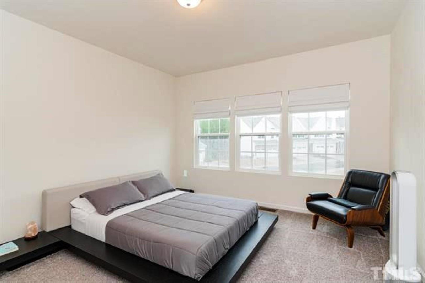 1118 Epiphany Road Morrisville, NC 27560 - Photo 10 of 20 a bedroom with a bed and a couch