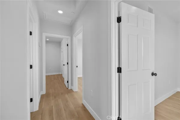a view of a hallway with wooden floor