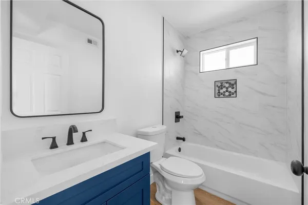 a bathroom with a sink toilet a mirror and shower